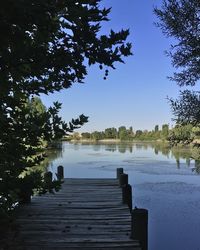 Pier over lake against sky