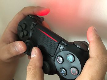 Cropped hands playing video game