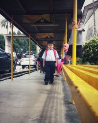 Full length portrait of boy on motorcycle