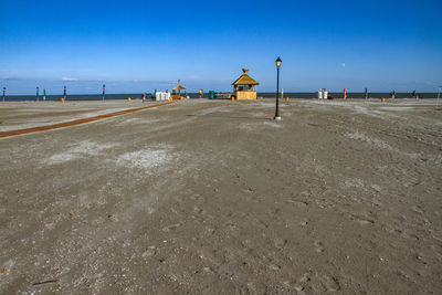 Scenic view of beach against clear blue sky