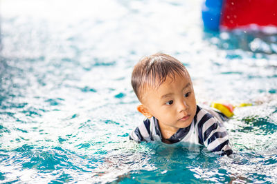 Close-up of boy playing in swimming pool