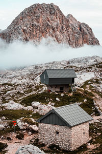 Built structure on snow covered land against mountains