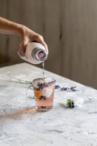 Cold refreshing tea with blueberry, lime and lavender on a hot summer day