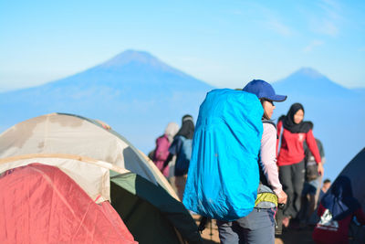 Girl with the big backpack on the mountain