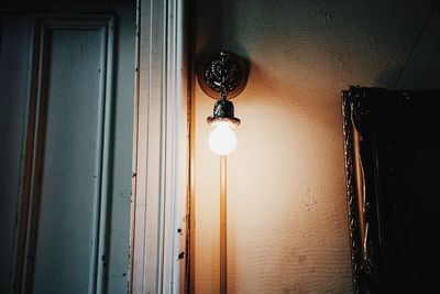 Low angle view of electric lamp hanging on ceiling