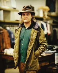 Portrait of man in warm clothing standing at store