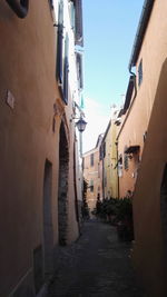 Alley amidst buildings against sky