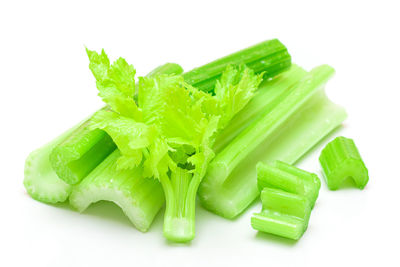 Close-up of green chili pepper against white background