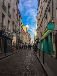 Street amidst buildings in city against sky