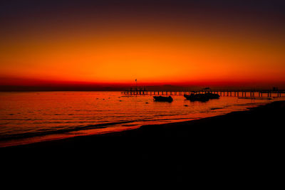 Scenic view of sea against orange sky