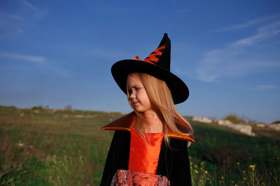 Full length of girl standing on field against sky