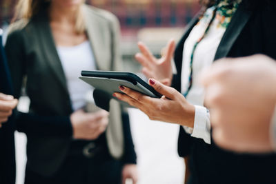 Midsection of woman using mobile phone