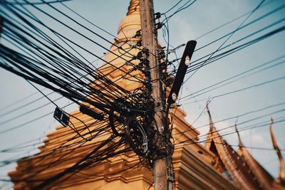 Low angle view of electricity pylon against sky