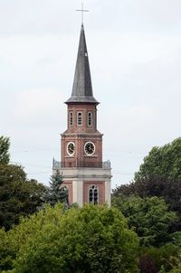 Low angle view of clock tower against sky