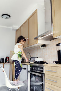 Girl preparing food in kitchen