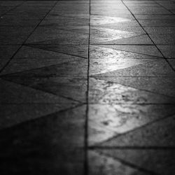 High angle view of shadow on tiled floor