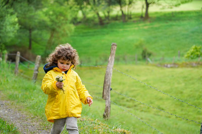 Full length of boy standing on field