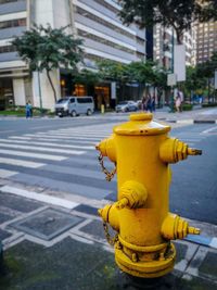 Close-up of yellow fire hydrant on street