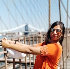 Portrait of young woman wearing sunglasses standing outdoors