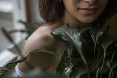 Close-up portrait of young woman at home