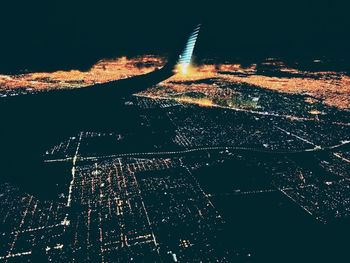 High angle view of illuminated cityscape against sky at night