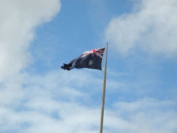 Low angle view of flag against sky