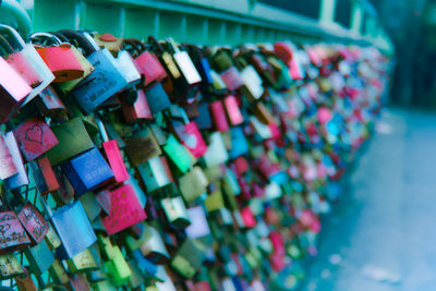Close-up of love locks hanging on railing