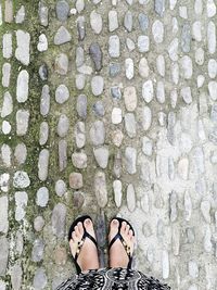 Low section of woman standing on tiled floor