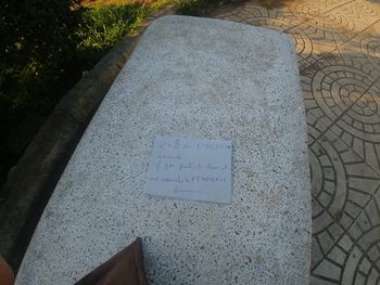 High angle view of text on stone at cemetery