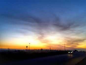 Cars on road at sunset