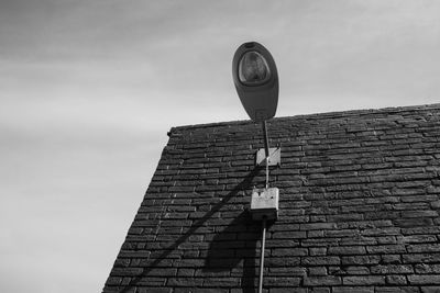 Low angle view of street light against building