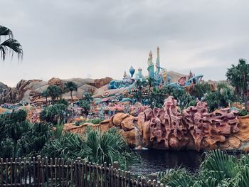 Panoramic shot of palm trees by sea against sky