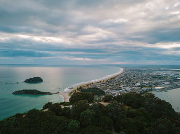 Aerial view of sea against cloudy sky