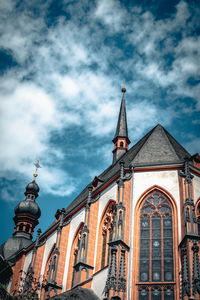 Low angle view of building against cloudy sky