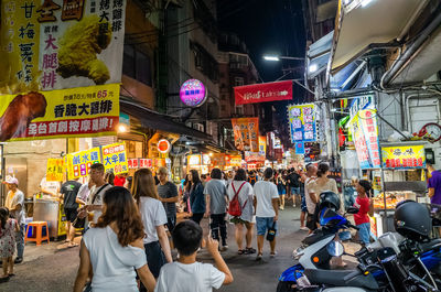 People on street in city at night