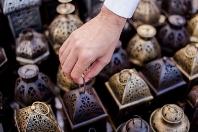 Cropped hand holding lantern