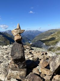 Rocks on mountain against blue sky