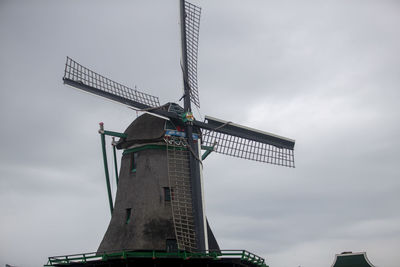 Low angle view of crane against sky