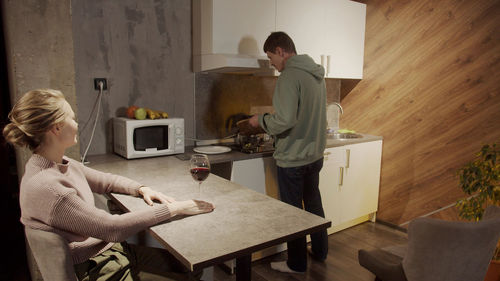 Couple sitting on table at home