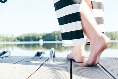 Low section of woman on boat against sky
