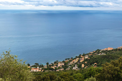 Scenic view of sea by buildings against sky