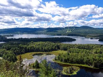 Scenic view of lake against sky - mont sourire, qc , canada