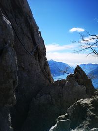 Rock formations on snow covered mountain against sky