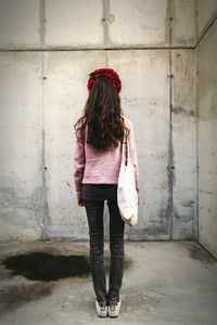 Full length of woman standing on railing