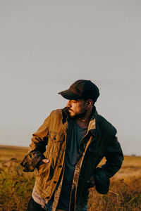 Man standing on field against clear sky