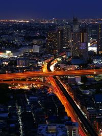 High angle view of illuminated city street and buildings at night