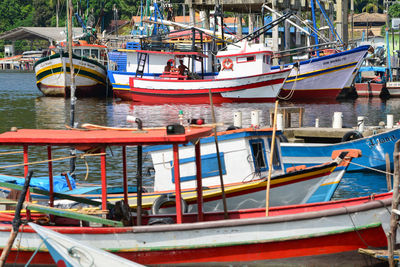 Boats moored at harbor