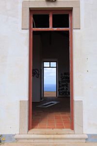 Open doors of building against sea