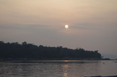 Scenic view of lake against sky at sunset