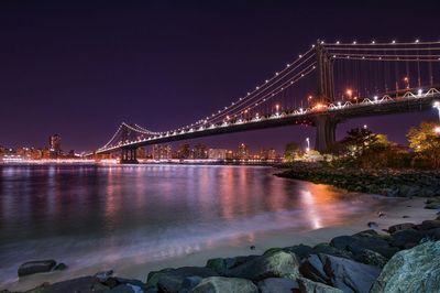 Illuminated bridge over river